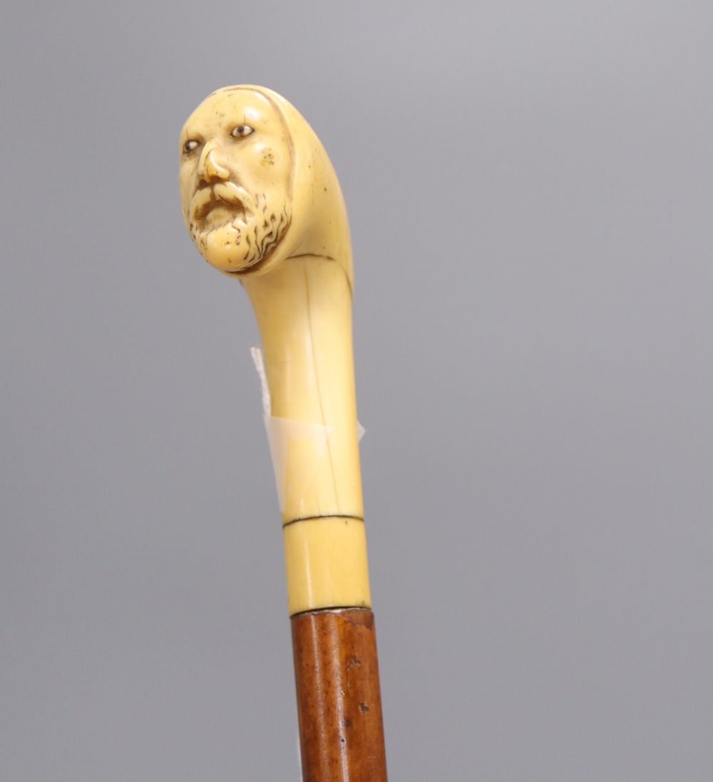 A Druids head carved cane, c.1860, length 85cm